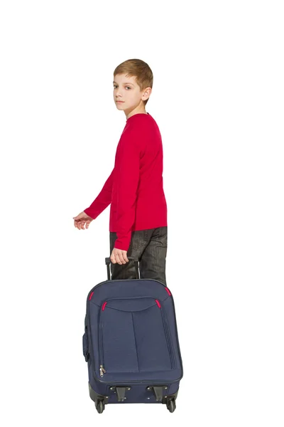 Boy holding travel bag walking away isolated on white — Stock Photo, Image