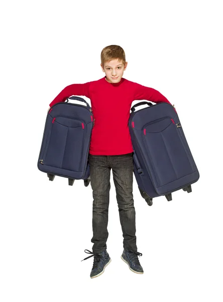 Happy boy jumping holding travel bags — Stock Photo, Image