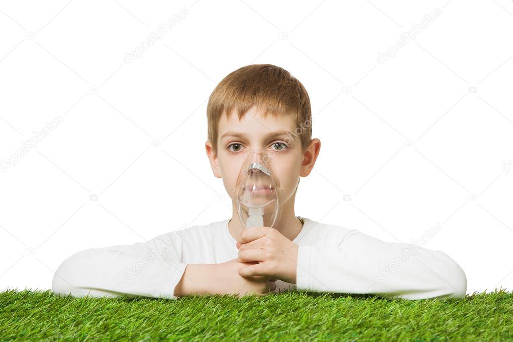 Boy in white using inhalator mask