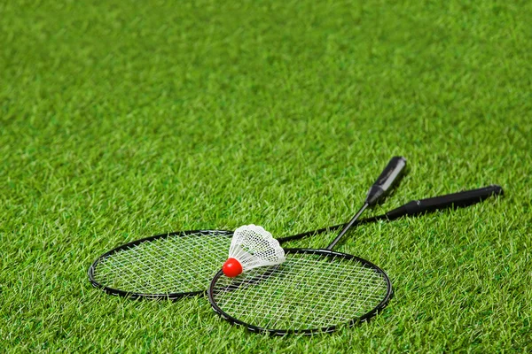 Cruzou raquetes de badminton com vaivém sobre ele — Fotografia de Stock