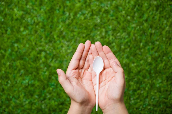 Human hands holding empty spoon — Stock Photo, Image