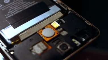 Parçalanmış cep telefonunun yakın plan görüntüsü. Cep telefonu tamiratı. Yavaş çekim