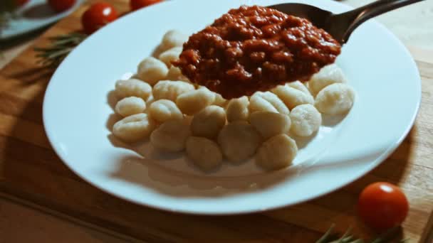 Gnocci mit Tomatensauce, die mit Parmesan bestreut werden. Mit einem Löffel verrühren. Angenehme Atmosphäre. 4k Video. — Stockvideo