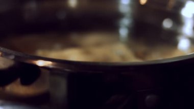 Ravioli 'yi kaynayan suyla birlikte tavaya koyarak yakın plan çek. Tipik bir İtalyan yemeği olan ravioli hazırlamak, eski İtalyan geleneğine göre ev yapımı. 4K video, makro