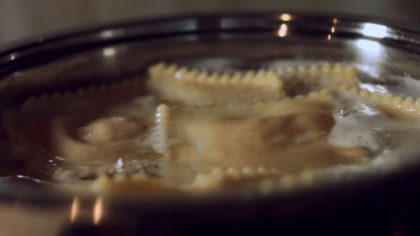 沸騰したお湯で鍋にラビオリ料理のクローズアップ.古代イタリアの伝統に従って自家製の典型的なイタリア料理、ラビオリを準備します。4Kビデオ — ストック動画