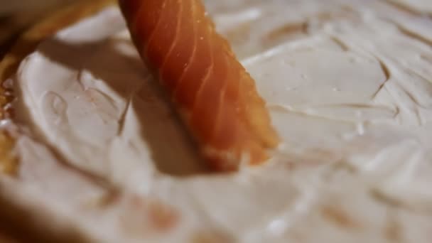 Thin tasty colorful pancakes. Macro view of womans hand laying salmon slices as filling on yellow pancake anointed with creamy cheese on a wooden board. 4K video. — Stock Footage Thin tasty colorful pancakes. Macro view of womans hand laying salmon slices as filling on yellow pancake anointed with creamy cheese on a wooden board. 4K video. Royalty Free Stock Footage