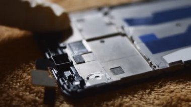 Yüzeyde duran akıllı telefonun yakın plan görüntüsü. Birisi ekranın detaylarını kasten bozmuş. Bozuk akıllı telefon. 4K video