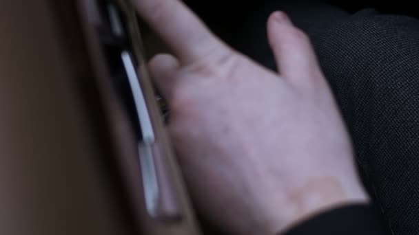 Bir arabanın içindeki elektrikli koltuk ayarları için kontrol düğmelerine basan erkeğin yakın görüntüsü. İç kapı düğmesi ayarlama düğmesi. 4K video — Stok video
