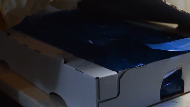 Widok z bliska na ręce w rękawiczkach otwierających pudełko pełne zamrożonych kurzej nóżki. Mrożone surowe mięso z kurczaka pokryte lodem. 4k wideo — Wideo stockowe