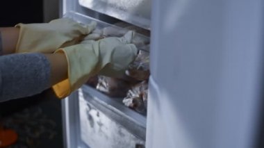Meat stock, meat reserve during the COVID-19 pandemic. Chicken meat storage and organization in a freezer. Woman puts in the fridge cut chicken. and closes freezers door. 4K video