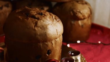 Noel için geleneksel İtalyan hamur işleri ve kurutulmuş meyveler. Milan 'ın tatlı ekmeği Panettone. Süsler, mumlar ve ışıklarla güzel bir Noel atmosferi var. Yüksek kalite 4k görüntü