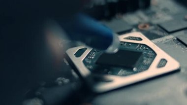 GPU Grafik Kartı. Teknisyenlerin yeni bir çipin üzerine termal macun dökerken makro görüntüsü. 4K video.