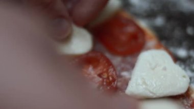 Fırın tepsisindeki pizzaya kalp şeklinde mozarella ekliyorum. Sevgililer Günü için kalp şeklinde pizza hazırlıyorum. Sevdiğim biri için. 4K video. Makro görünüm