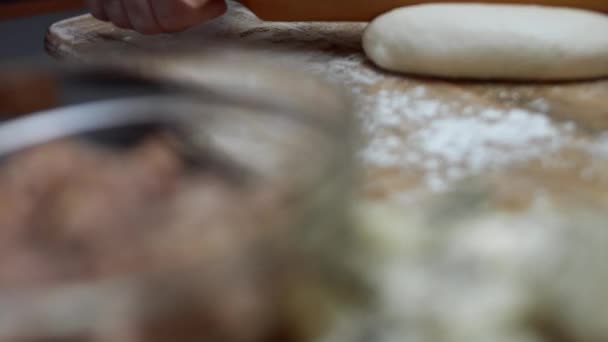 Rolling out fresh dough for tuna pizza on wooden cutting board. Preparing heart shaped tuna pizza for Valentines Day for a loved one. 4K video — Stock Video