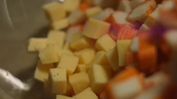 Salada de caranguejo em um prato decorado com queijo ralado, endro e caviar de salmão vermelho. Salada de palitos de caranguejo, queijo, pepino, milho enlatado, maionese e ovos na cozinha em casa. Prazo de validade — Vídeo de Stock