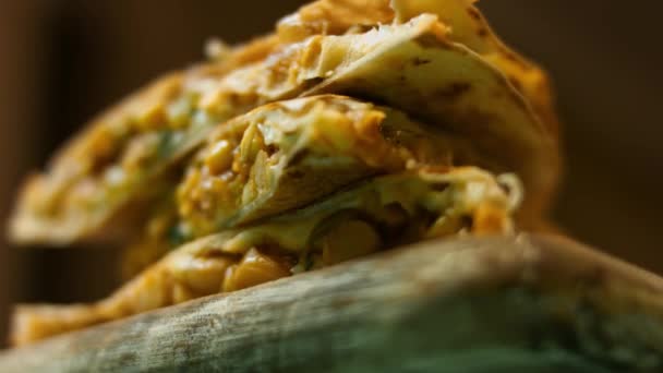 Freshly fried hot vegetable quesadilla on a wooden cutting board. Process of making mexican quesadillas. Macro view — Stock Video