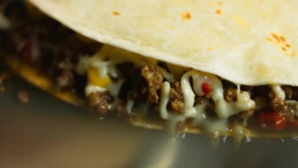 Frying a freshly wraped beef quesadilla on a frying pan. Process of making mexican quesadillas. Macro view — Stock Video