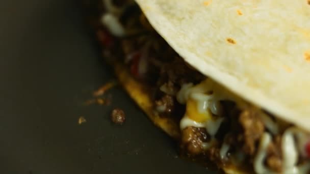 Frying a freshly wraped beef quesadilla on a frying pan. Process of making mexican quesadillas. Macro view — Stock Video