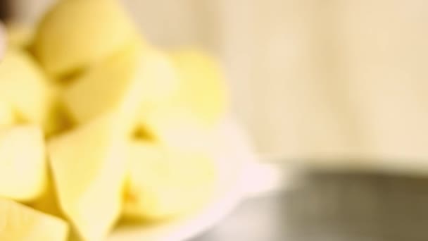 Női kéz transzferek vágott arany burgonya forró vízbe egy edényben. A tökéletes sütőben sült burgonya főzésének folyamata — Stock videók