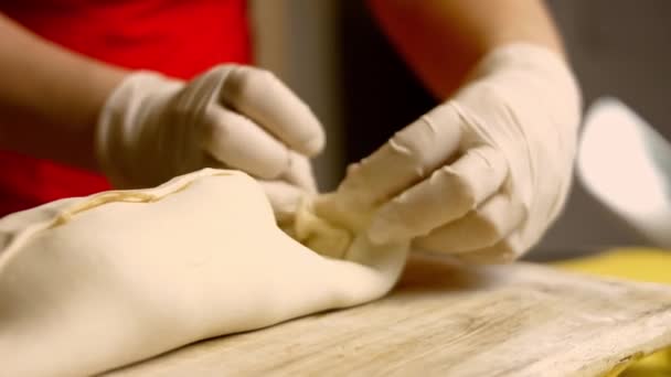 Hands puts bowl with beaten egg close to formed raw beef Wellington. 4k video — Stock Video