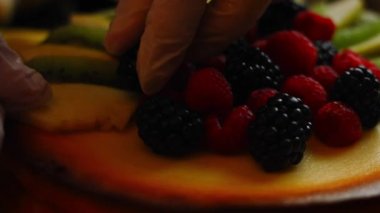 Cheesekake 'in üzerine elma ve kivi dilimleri koy. 4k video
