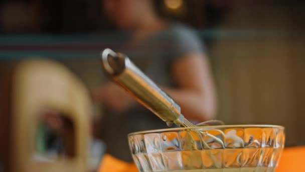 Add ingredients with a teaspoon of ice cream in a transparent bowl. 4k video — Stock Video