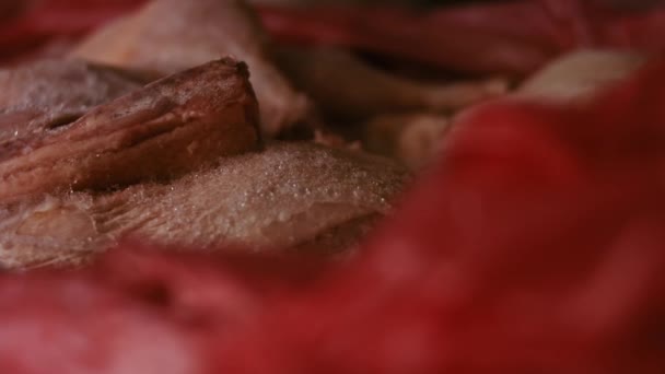 Close-up view of hands in gloves packing chicken legs from a box into individual plastic bags. Process of freezing meat for further use at home. 4k video with light play — Stock Video