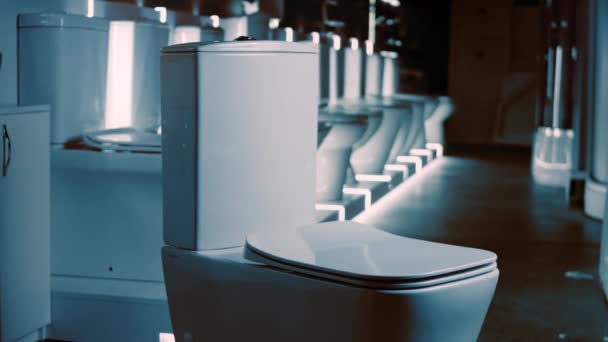 Rotating Toilet bowl. Studio filming. In the background a row of toilets. 4k video — Stock Video