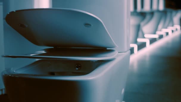 Rotating Toilet bowl. Studio filming. In the background a row of toilets. 4k video — Stock Video