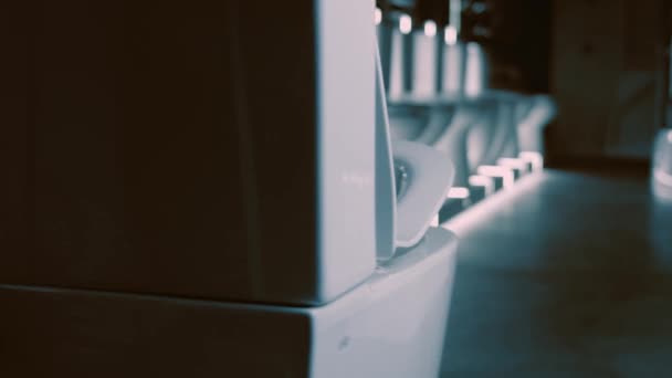 Rotating Toilet bowl. Studio filming. In the background a row of toilets. 4k video — Stock Video