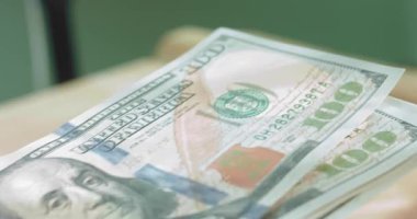 Bir el Amerikan doları teklif eder, diğeri de parayı alır..