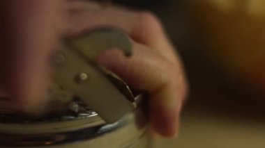 Using an old manual can opener to open a can, macro view.