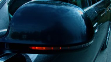 Car side mirror turn signal, slow motion.