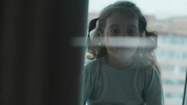 Yüzünde ortaçağ şatosu resmi olan sevimli küçük bir kız kameraya bakıyor. Mimarlık konsepti.