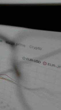 Dış döviz çiftlerini gösteren ticaret platformu ve bir çizgi grafiği, görüş gözlükleriyle görünüm.