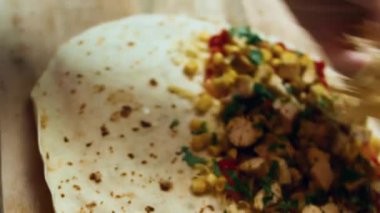 Tavuklu quesadilla hazırlamak için diğer malzemelerin üzerine dilimlenmiş peynir katıyorum..