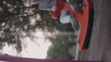 Sevimli sarışın küçük kız açık havada sallanıyor..