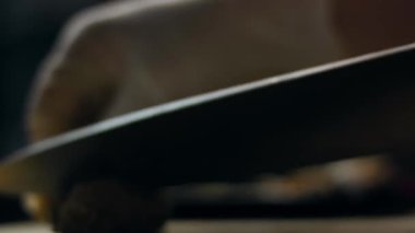 Kesme tahtasında pişmiş sığır eti doğrayan eller..