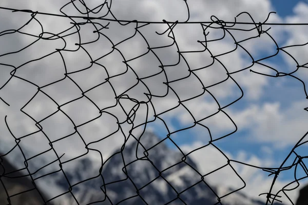 Torn metal mesh. Background — Stock Photo, Image