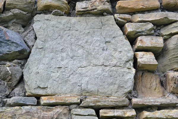 Background. Wall assembled from fragments of rocks. — Stock Photo, Image