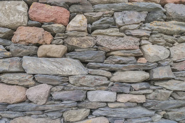 Contesto. Parete assemblata da frammenti di rocce — Foto Stock