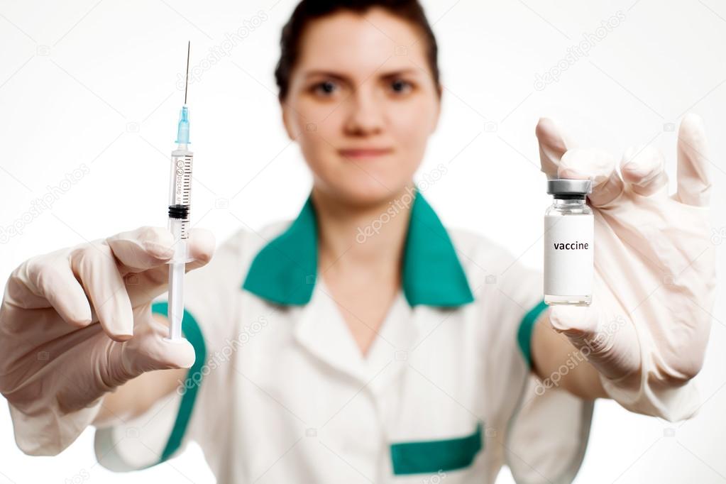 Medic holding syringe and capsule with vaccine in hand. Vaccination. Influenza