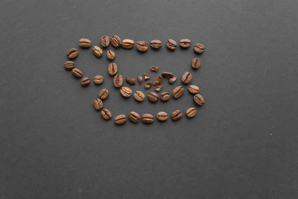 Filiżanka Kawy Jest Wyłożona Paloną Fasolą Czarnym Tle Widok Góry — Zdjęcie stockowe