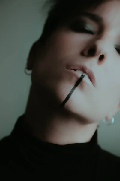 Güçlü makyajlı tanınmayan bir kadının portresi.