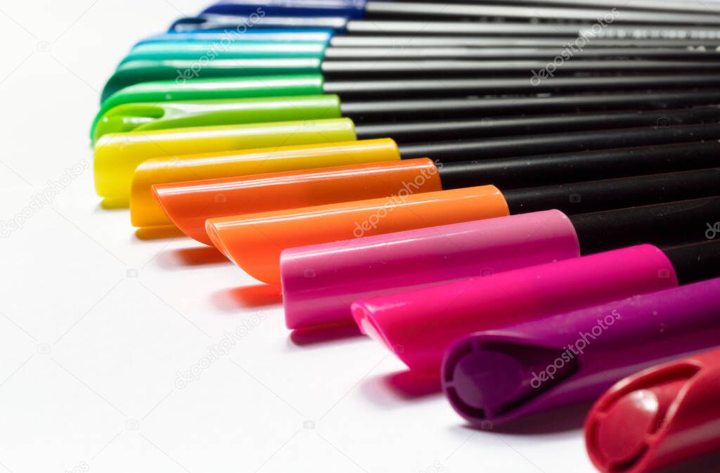 Close up of a set of chromatically arranged markers isolated on a white background.