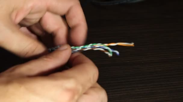 Telecommunications engineer working with colored wires — Stock Video