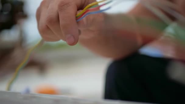 Man plugging in a fiber optic hub cable — Stock Video