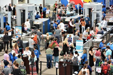 Travelers at Denver International Airport going thru the security check points. clipart
