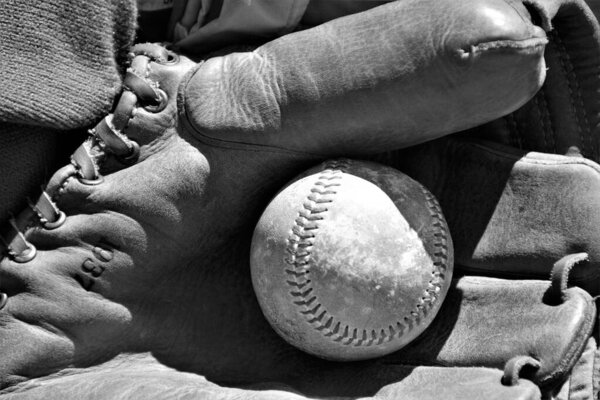 Old baseball and glove used in the American sport of Baseball. 