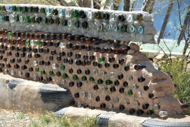 Duvar dolgusu yapmak için şişe toplamak çevreyi iyileştirmeye yardımcı olacak ve böylece ucuz yapı malzemeleri yaratılacak..